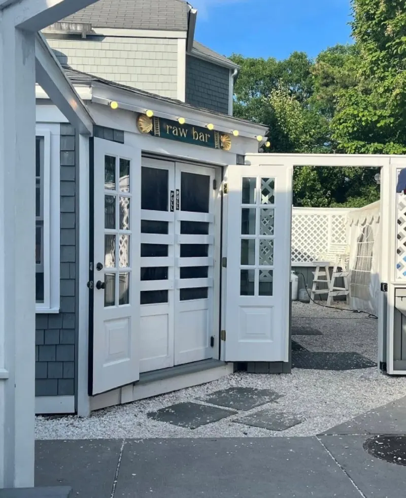 Raw Bar entrance and picnic tables