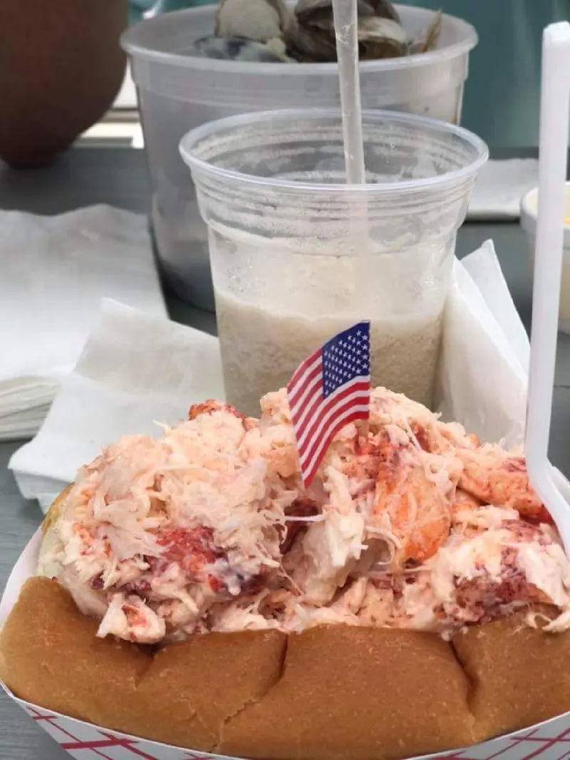 Lobster roll and drink with a small flag