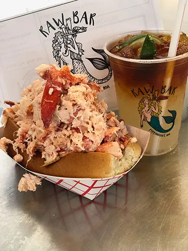Raw Bar lobster roll next to a branded Raw Bar cup