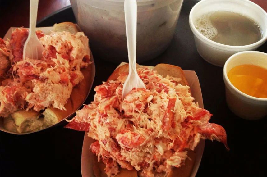 Two overflowing Raw Bar lobster rolls